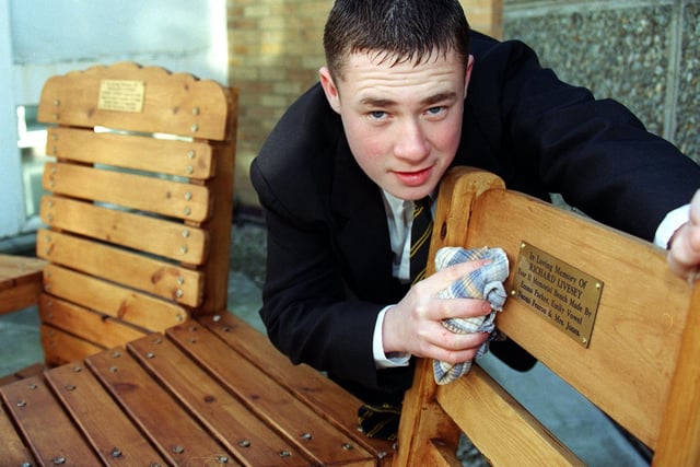 Lee Ogden, who was 16 when this photo was taken in 1999, with a bench that had been made in memory of fellow student Richard Livesey who died after having an epileptic fit.