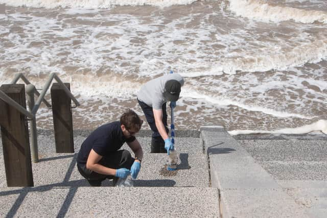 Water samples are taken from Cleveleys beach following a pollution incident (Credit: Daniel Martino)