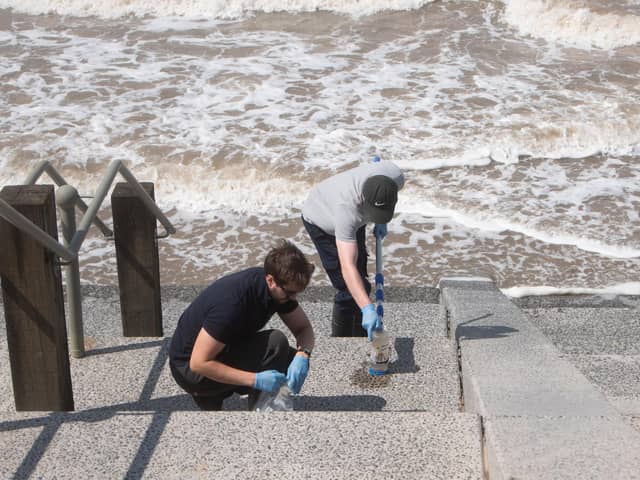 Water samples are taken from Cleveleys beach following a pollution incident (Credit: Daniel Martino)