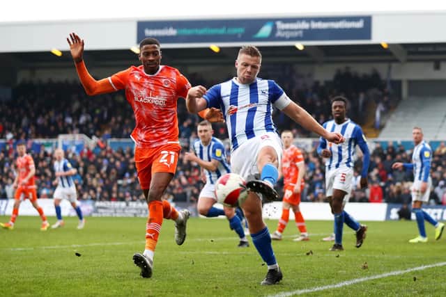 HARTLEPOOL, ENGLAND - JANUARY 08: Nicky Featherstone of Hartlepool United clears the ball whilst being chased by Marvin Ekpiteta of Blackpool during the Emirates FA Cup Third Round match between Hartlepool United and Blackpool at Suit Direct Stadium on January 08, 2022 in Hartlepool, England. (Photo by George Wood/Getty Images)
