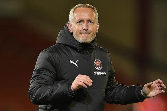 Neil Critchley celebrates with the travelling fans at the full-time whistle