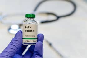 Poliomyelitis virus vaccine with stethoscope and syringe at the background