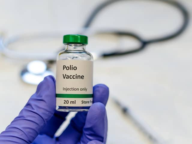 Poliomyelitis virus vaccine with stethoscope and syringe at the background