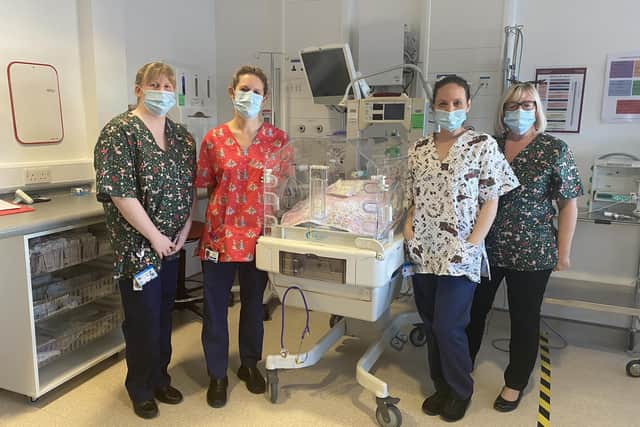 Sarah Heydon (neonatal sister), Gillian Jackson (nursery nurse), Sarah Steward (practice development sister), and Julie Kearney (matron) wearing the festive scrubs at Blackpool Victoria Hospital's neonatal unit