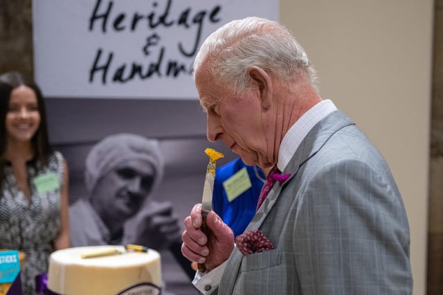 King Charles III smells some cheese inside Lancaster Castle during his visit to Lancaster. Photo: Kelvin Lister-Stuttard.