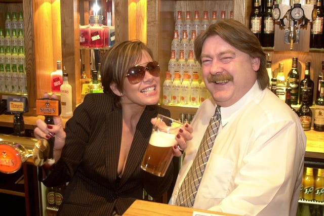 Belle Vue landlord Dave Wise is pictured with Gill Penny - a Victoria Beckham lookalike - at the reopening of the pub in 2002