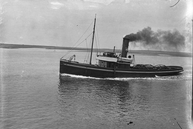 Steam Tug Enterprise, around 1912. It was a Preston Corporation tug heading south in Walney Channel, there's a man waving from bridge. She was wrecked in the Ribble estuary in 1931