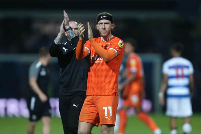 Josh Bowler applauds the Blackpool fans at the final whistle
