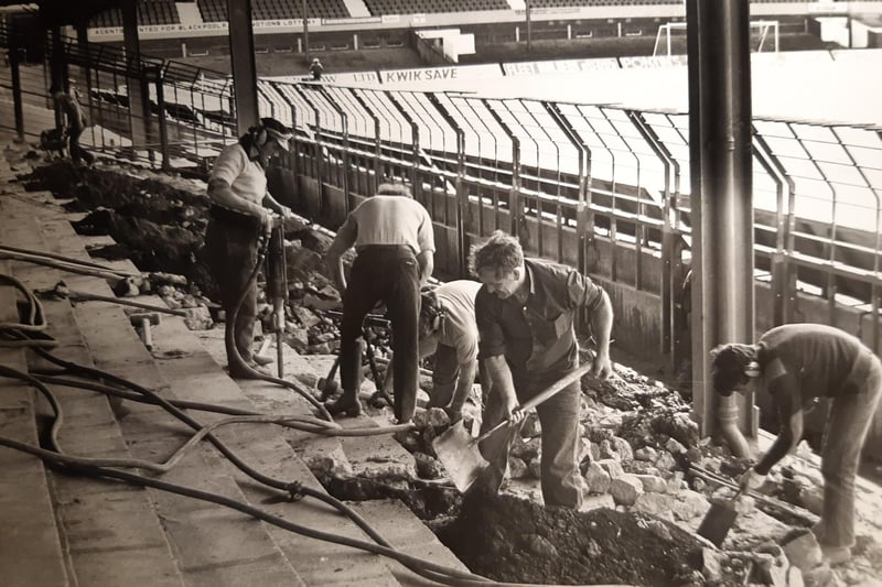 The caption on the back of this photo from August 1980 says :'Heigh Ho - it's a busy life as Blackpool's bid to improve ground conditions gets under way in Scratching Shed'