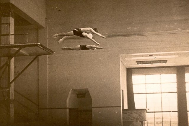 Pauline Nicholls, an unknown male and Joyce Gardiner dive from the five metre board at Derby Baths, in the early 1940s