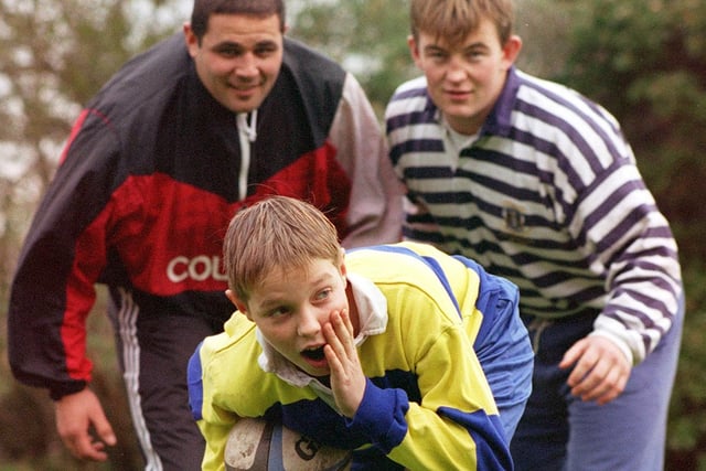 Captain of Hodgson High School U14s Rugby team Mark Alcock being tackled by Fylde Rugby Club professionals Matt Filipo and Richard Hanson in 1997
