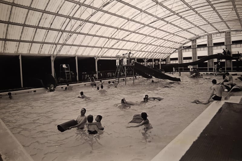 Giant slides and floating inflatables toys provide plenty of fun at the indoor pool in August 1987