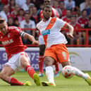 NOTTINGHAM, ENGLAND - AUGUST 09:  Chris Cohen of Nottingham Forest tackles Jacob Mellis of Blackpool during the Sky Bet Championship match between Nottingham Forest and Blackpool at City Ground on August 9, 2014 in Nottingham, England.  (Photo by Tony Marshall/Getty Images)