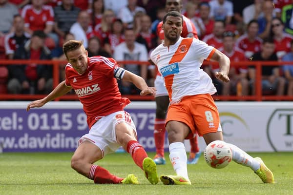 NOTTINGHAM, ENGLAND - AUGUST 09:  Chris Cohen of Nottingham Forest tackles Jacob Mellis of Blackpool during the Sky Bet Championship match between Nottingham Forest and Blackpool at City Ground on August 9, 2014 in Nottingham, England.  (Photo by Tony Marshall/Getty Images)