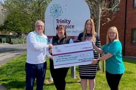 Steve O'Keeffe and wife Louise present their Herons' Reach captains' cheque for Trinity Hospice