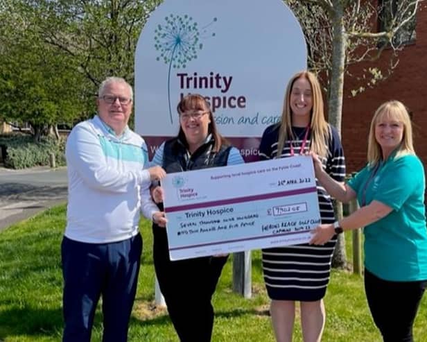 Steve O'Keeffe and wife Louise present their Herons' Reach captains' cheque for Trinity Hospice