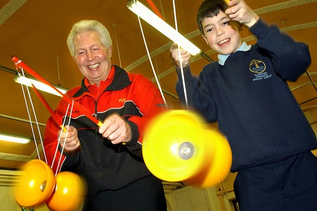Blackpool Circus School at Claremont Primary School. Yuri Gridneff and 11- year-old Haydn Miller demonstrating spinning the Diablo to the other pupils, 2004