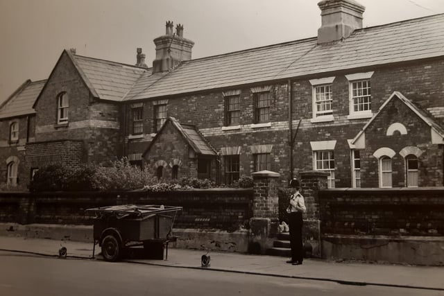 These are some of the oldest houses in Fleetwood. They are on Abbotts Walk facing the Mount Pub. The photo is undated but looks like a 1980s scene and on the back of the picture is says bomb shells had been found, hence the police officer