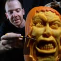 Pumpkin carver Simon McMinnis with one of his masterpieces