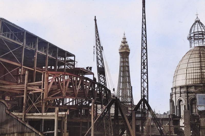 Blackpool Tower is the focal point of this colourised black and white picture with the Winter Gardens to the right and construction work in the foreground