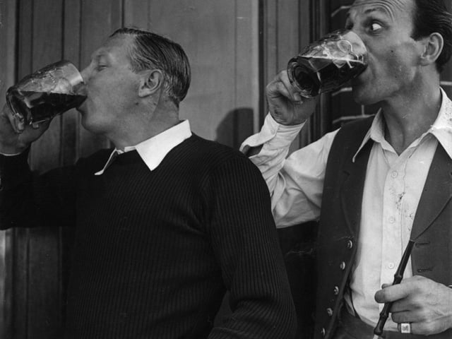 George Formby celebrates winning the Theatrical Challenge horse race at Squires Gate Blackpool with fellow rider Terry-Thomas in 1950