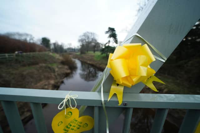 The messages have been written on yellow ribbons on a bridge over the River Wyre in the village (Credit: Peter Byrne/PA Wire)
