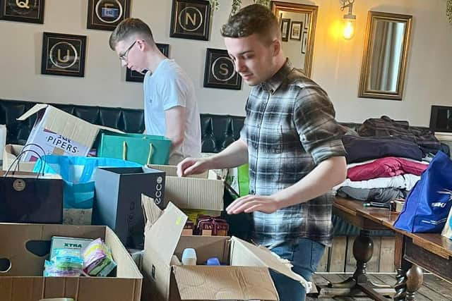 Staff at Red Fox and Peacock pubs, James and Sam, collecting aid for Ukraine