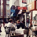 The Coffee Pot and its outdoor tables with Thomas Cook and Barclays Bank beyond in Birley Street