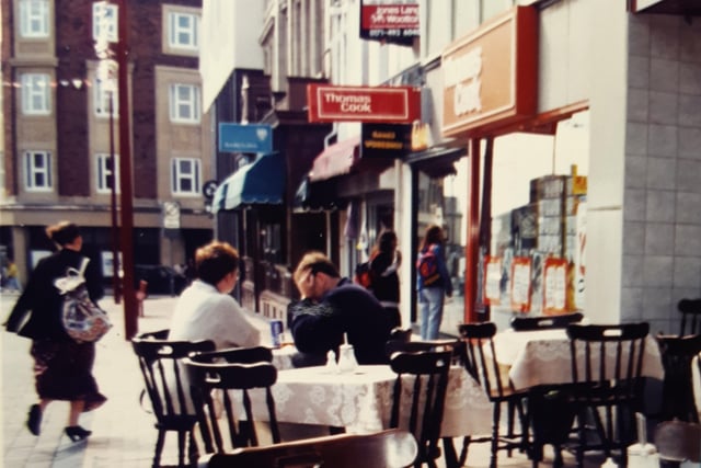 The Coffee Pot and its outdoor tables with Thomas Cook and Barclays Bank beyond in Birley Street