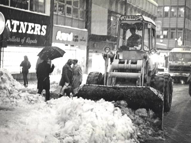 A strange sight for Blackpool as a bulldozer clears a path for cars in the town centre during heavy snowfall