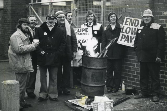 A brazier helps keep out the cold for pickets at the Rigby Road cleansing department, in Blackpool, 1979