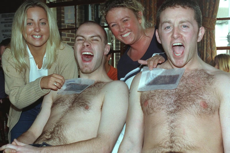 Neil Spiers (left) and Rob Booth suffer the agony of having their chests waxed for Children In Need by Debbie Kenny and Julia Cope at the Clifton Arms Pub, 1998