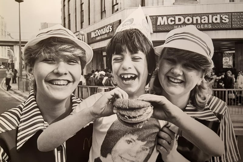 This photo was taken when Blackpool town centre McDonald's opened in April 1982. Six year old Lee Scott, of Charnley Road tucks into a Big Mac with Angela Gill (left) and Alison Ankers. Look at the queue behind them of people waiting for their first taste of McDonald's