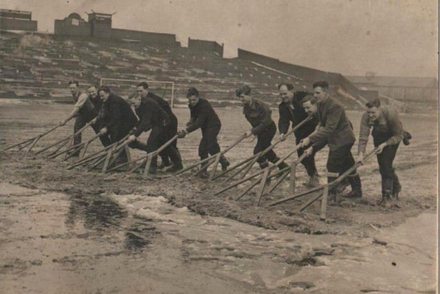 Off duty firemen help clearing  snow from the pitch at Bloomfield Road football ground prior to a cup tie. The caption says 1940s/1950s, can anyone put an exact date to this?