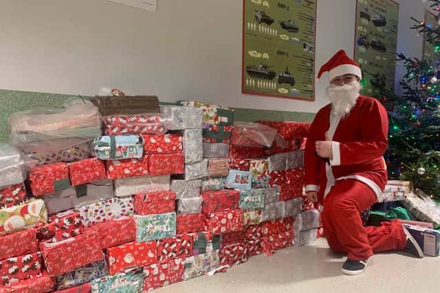 Trooper Anthony Finch, dressed as Santa, with all the festive shoe boxes