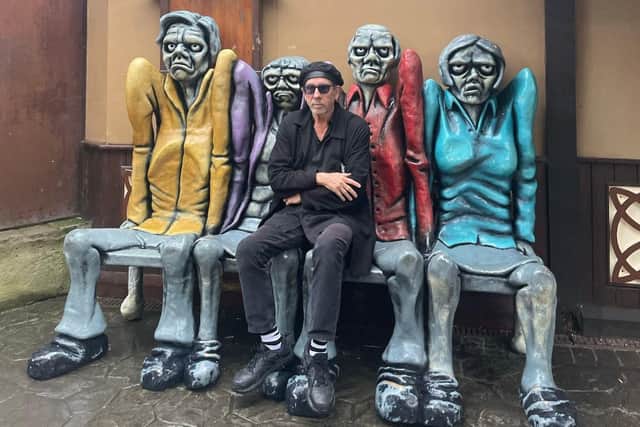 Hollywood film director Tim Burton outside the Blackpool Pleasure Beach Ghost Train on Thursday, October 5. He said he'd love to have the ghoulish bench outside the ghost train "in his house" if he could. (Picture by Blackpool Pleasure Beach)