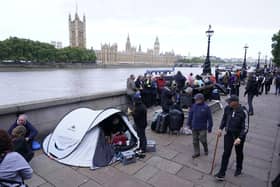 Members of the public join the queue on the South Bank, as they wait to view Queen Elizabeth II lying in state ahead of her funeral on Monday