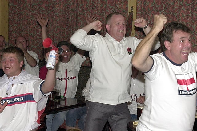 Fans celebrate during the England v Sweden World Cup match at the Mere Park Hotel in 2002