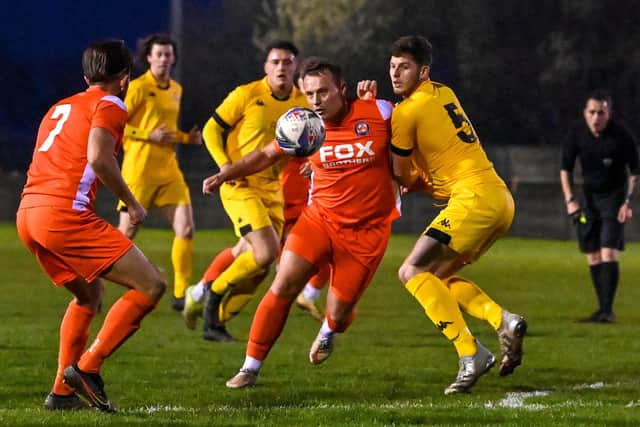 AFC Blackpool's Ben Duffield tries to force his way through the Ashton Town defence Picture: ADAM GEE