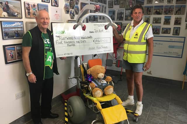 David Nuttall (left), ASDA’s Community Champion representing the Fleetwood Store, presents the cheque to Mick Gray of Fleetwood Beach Wheelchairs.