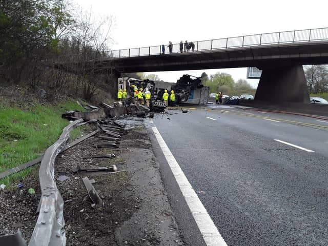 Dramatic photographs show the aftermath of a horror motorway crash which has left a lorry split in half.