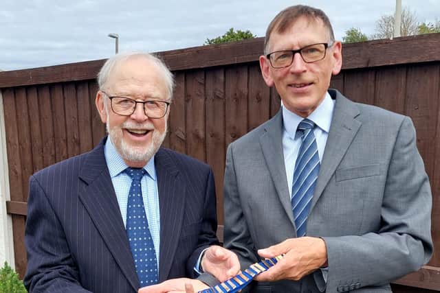 MIke Fenton (right) hands over the lytham Probus president's chain of office to Elfyn Gittins