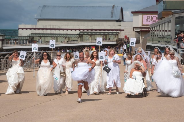 Two of the brides were men who agreed to dress up on the day to help a good cause!