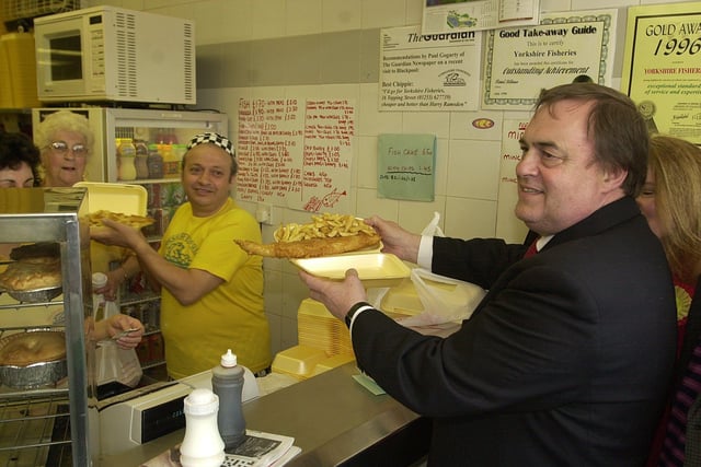 John Prescott is served with fish and chips by George Vassiliou at Yorkshire Fisheries in Topping Street
