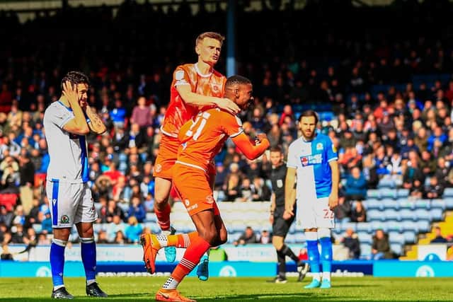 Marvin Ekpiteta is jumped on by Callum Connolly after levelling for Blackpool