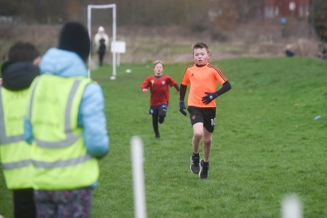 A participant in Junior Parkrun at Park View 4U shows a turn of speeed to head for the finish line.