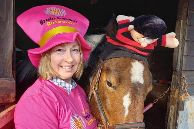 Joanna Dobson, of Midgeland Road Riding School, with one of the horses on Wear a Hat day for Brain Tumour Research