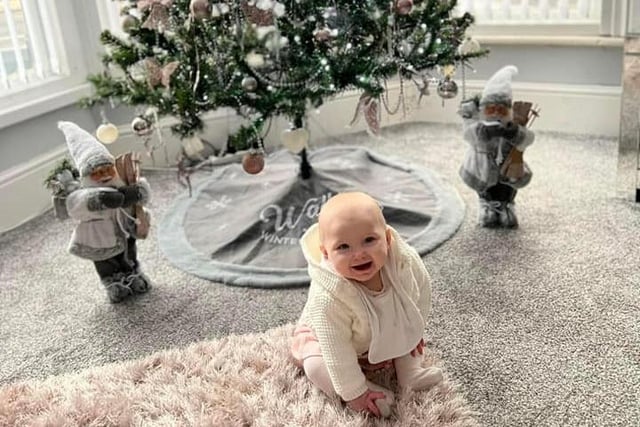 Aria-Rose gives a helping hand with decorating the tree.