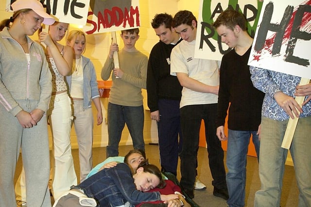Performing arts students at Blackpool and Fylde College rehearsing for their production of 'Road'. Rachel Hough and Craig Long (on the bed) 'dream' about the problems in a Lancashire town, represented by the protesters
