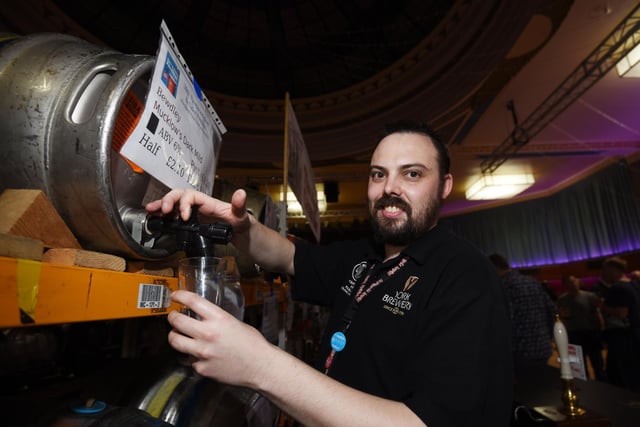 Matt Walker pours a pint behind the bar.